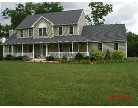 39 Quabbin Path Sutton, MA 01590 - Photo 1 of 1 a front view of a house with a yard and potted plants