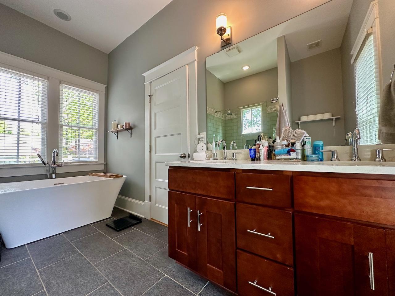 605 Elm Street Raleigh, NC 27604 - Photo 14 of 23 a spacious bathroom with a tub sink and mirror