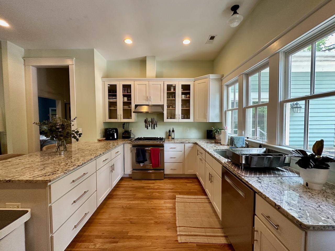 605 Elm Street Raleigh, NC 27604 - Photo 9 of 23 a large kitchen with stainless steel appliances granite countertop a sink and cabinets
