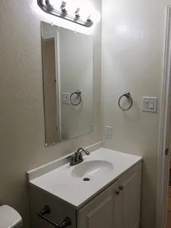 a bathroom with a sink and a mirror