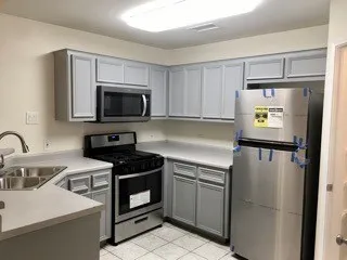 a kitchen with a sink appliances and cabinets