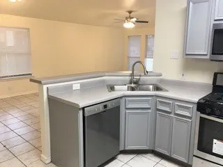 a kitchen with a sink cabinets and appliances