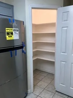 a view of walk in closet with empty racks