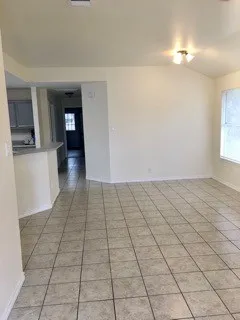 a view of a livingroom with an empty space and a window
