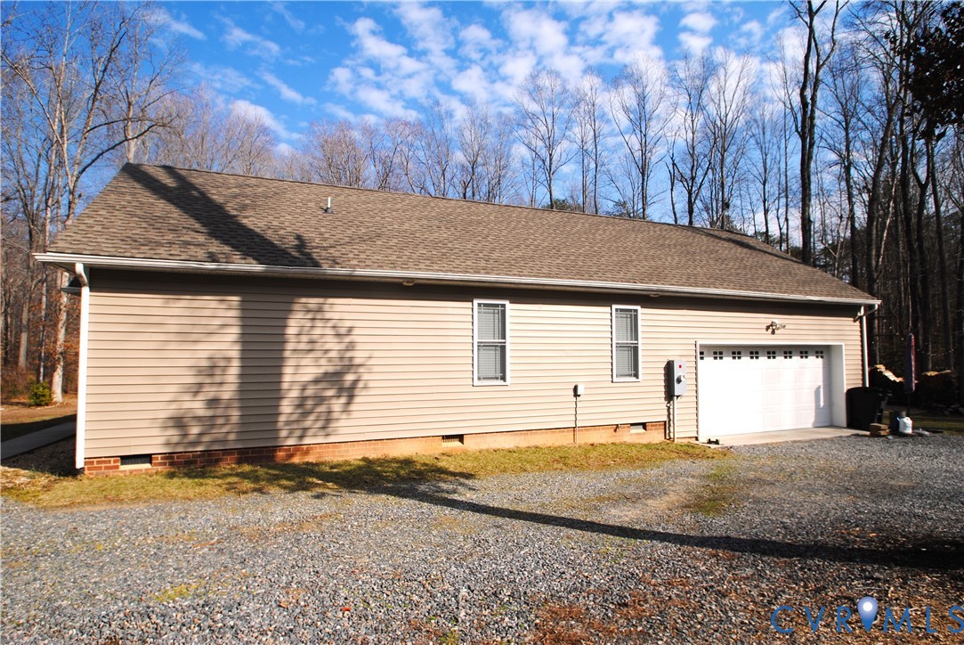722 Signboard Road Bumpass, VA 23024 - Photo 62 of 65 a view of a house with a yard and garage