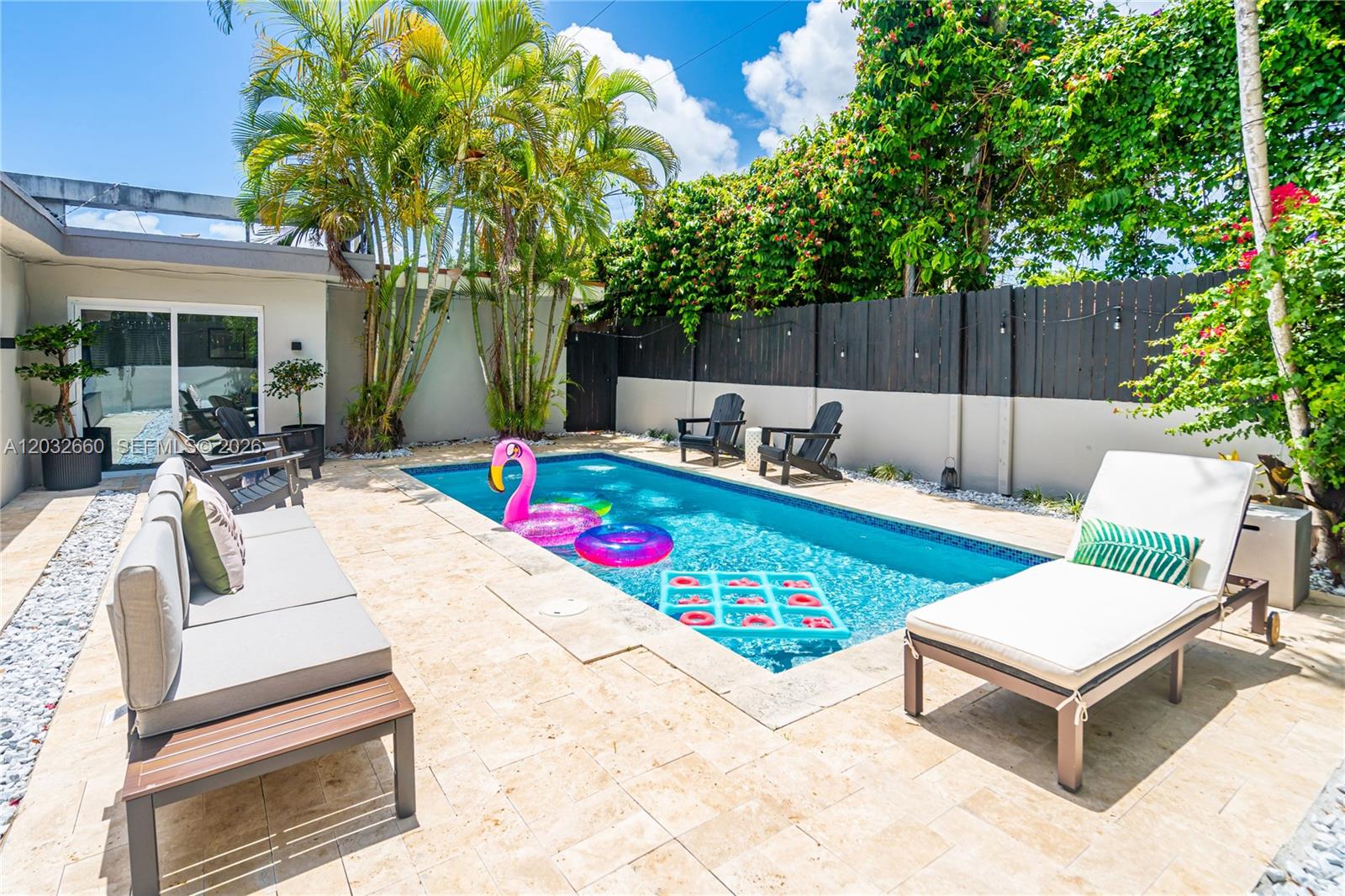 520 Southwest 22nd Road Miami, FL 33129 - Photo 3 of 76 a view of outdoor sitting area with furniture and wooden fence