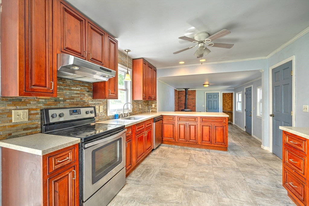 109 Greenwich Plains Road Ware, MA 01082 - Photo 8 of 42 a kitchen with stainless steel appliances granite countertop a stove a sink and a refrigerator