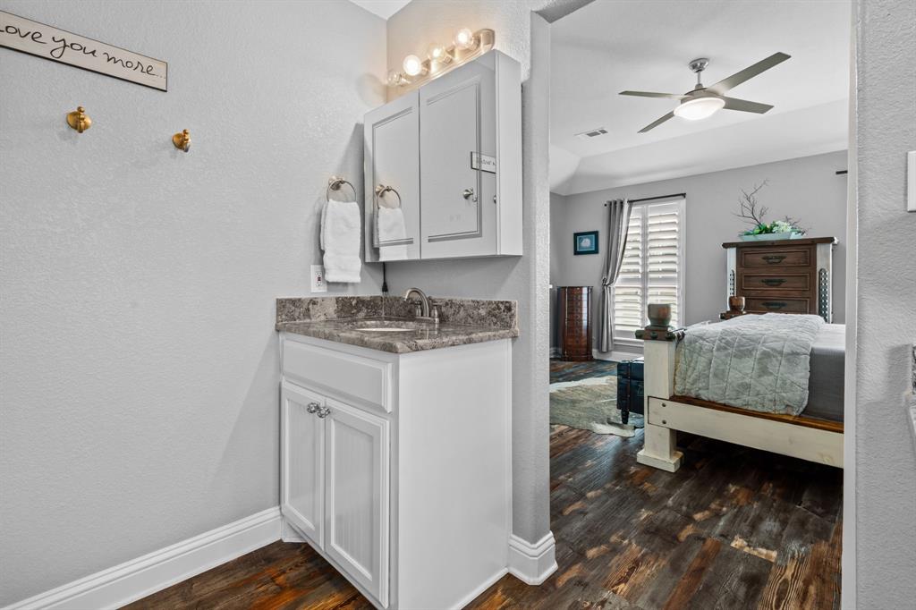 175 Porter Road Bartonville, TX 76226 - Photo 22 of 40 a en suite bathroom with a granite countertop sink and a mirror