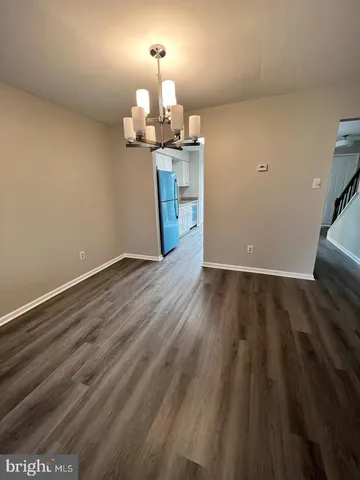 a view of a kitchen with wooden floor and a sink