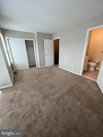 a view of an empty room and a window