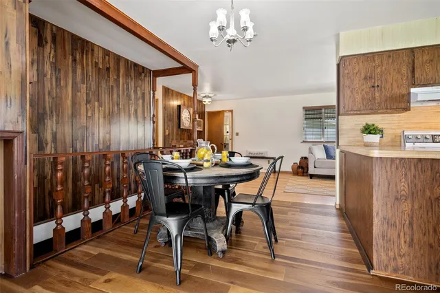 a view of a dining room with furniture and chandelier