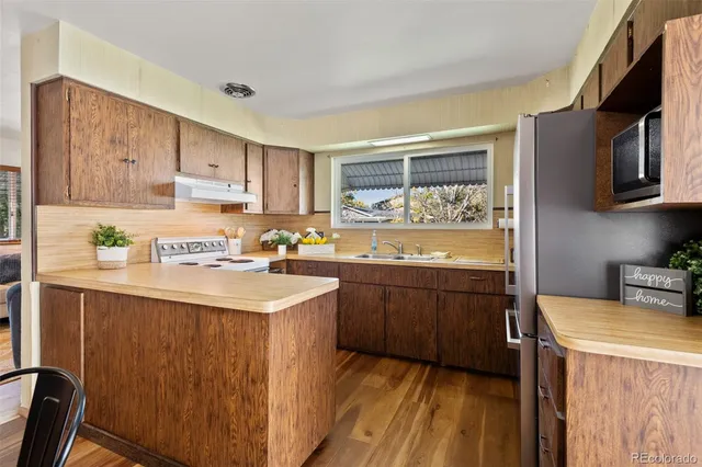 a kitchen with a sink stove and cabinets