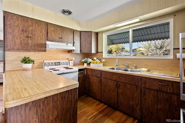 a kitchen with stainless steel appliances wooden cabinets a stove and a refrigerator