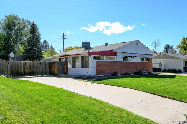 a front view of a house with a garden and yard