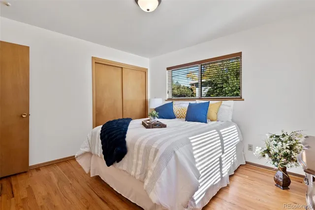 a bedroom with a bed and a potted plant