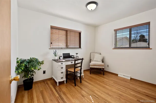 a view of a workspace with furniture and a potted plant
