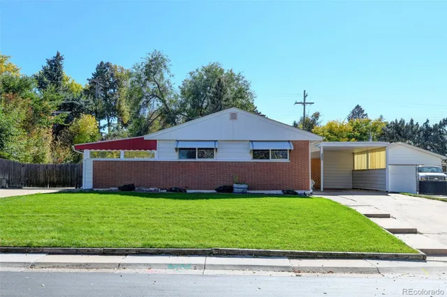 a view of a house with a wooden fence