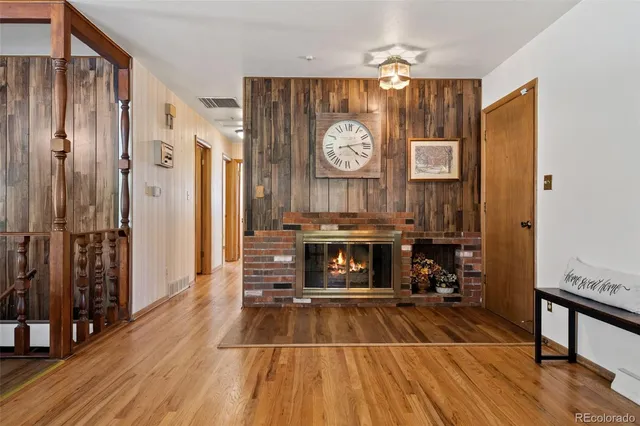 a living room with stainless steel appliances lots of wooden floor