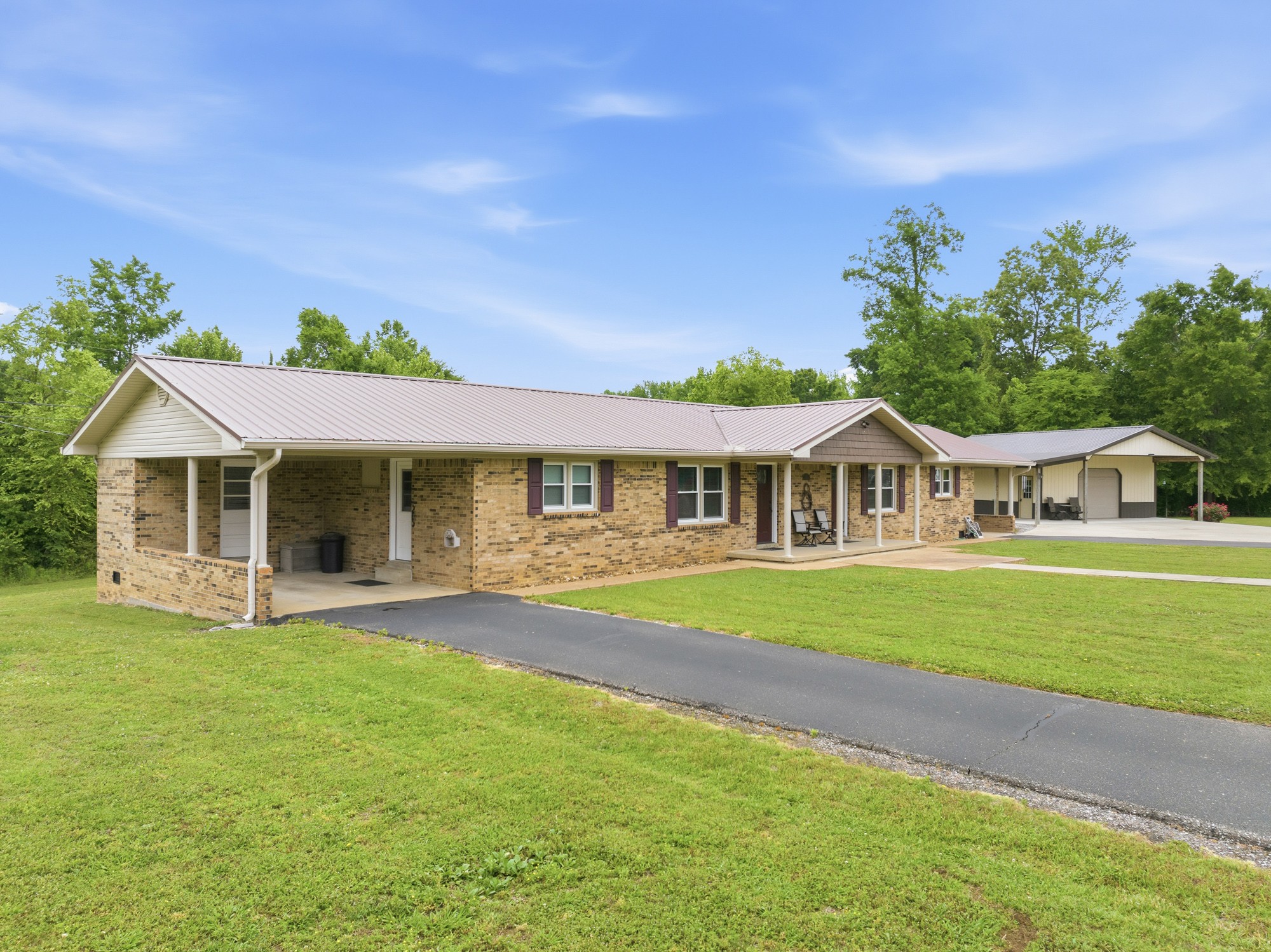 944 Brooksie Thompson Road Decaturville, TN 38329 - Photo 40 of 47 a front view of a house with a garden and trees