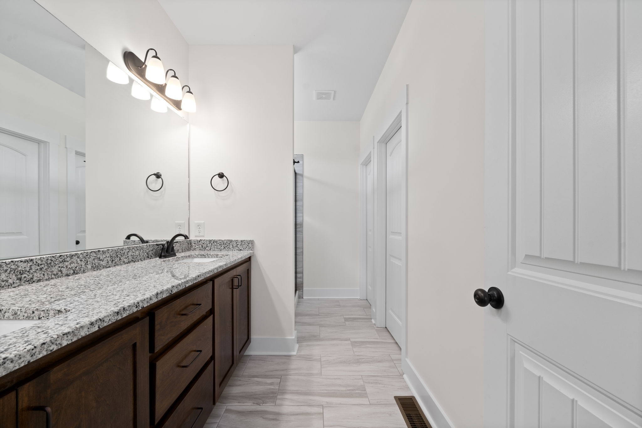 189 Dewberry Road Clarksville, TN 37042 - Photo 30 of 52 a bathroom with a granite countertop sink a large mirror and a shower