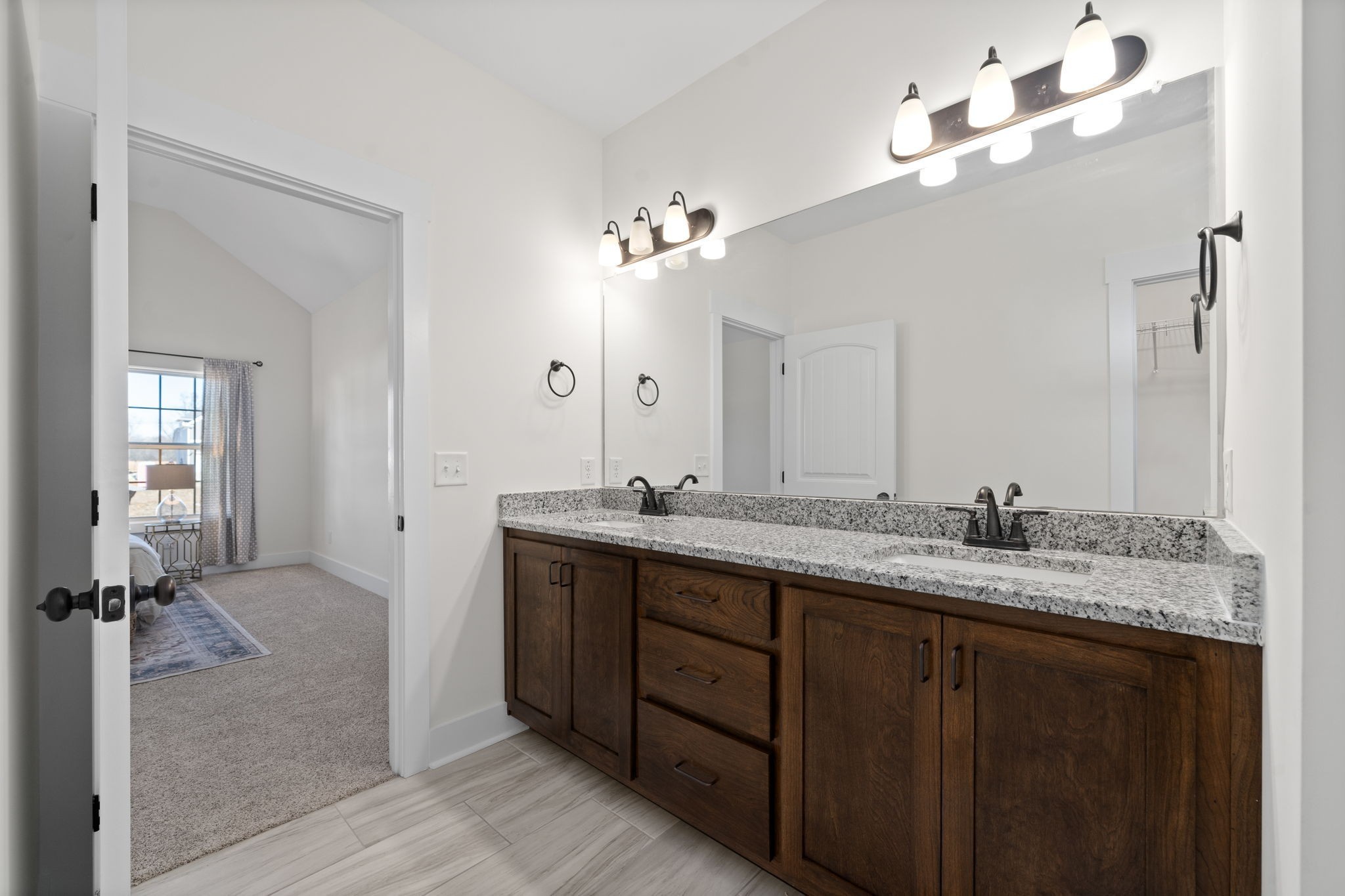 189 Dewberry Road Clarksville, TN 37042 - Photo 32 of 52 a bathroom with a granite countertop sink a mirror and a vanity