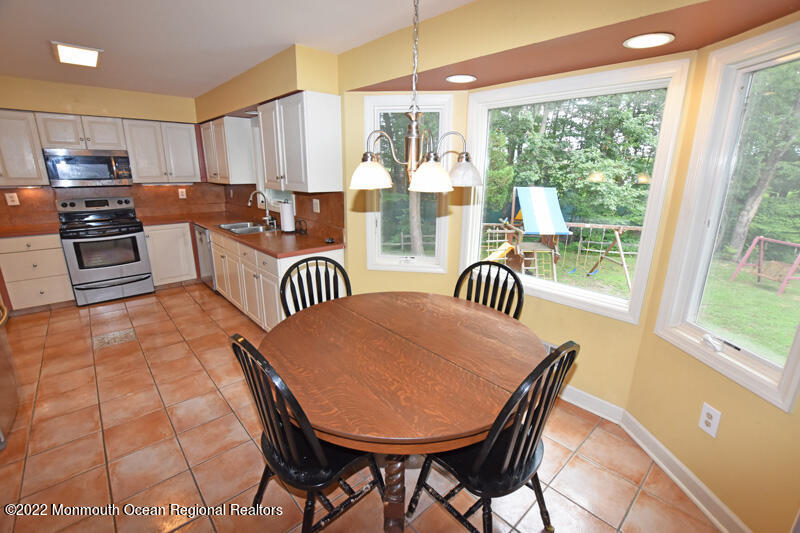 84 Daum Road Manalapan, NJ 07726 - Photo 14 of 50 a dining room with furniture and large windows