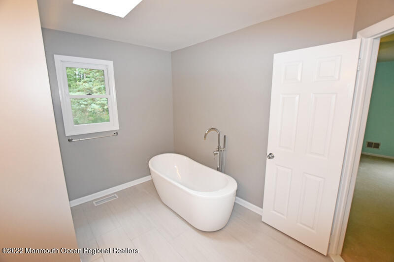 84 Daum Road Manalapan, NJ 07726 - Photo 33 of 50 a bathroom with a toilet and a window