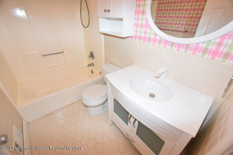 84 Daum Road Manalapan, NJ 07726 - Photo 38 of 50 a bathroom with a sink a toilet and a mirror