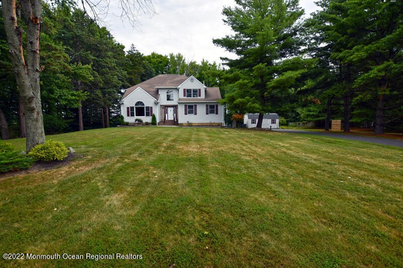 84 Daum Road Manalapan, NJ 07726 - Photo 44 of 50 a front view of a house with garden