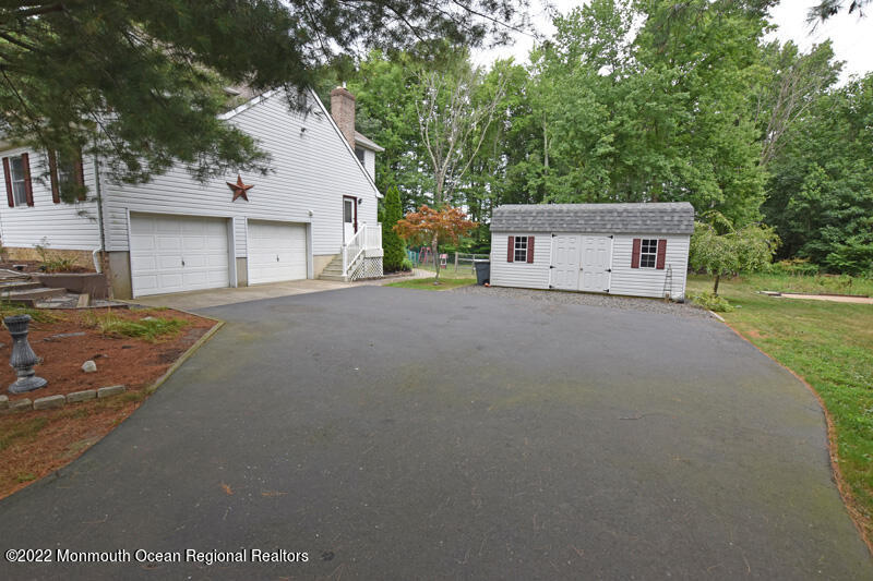 84 Daum Road Manalapan, NJ 07726 - Photo 46 of 50 a view of a house with a yard and garage