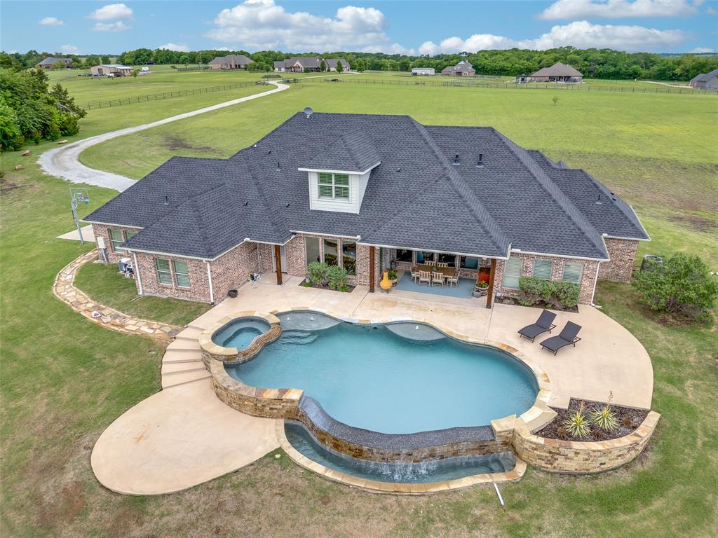 an aerial view of a house with yard swimming pool and outdoor seating
