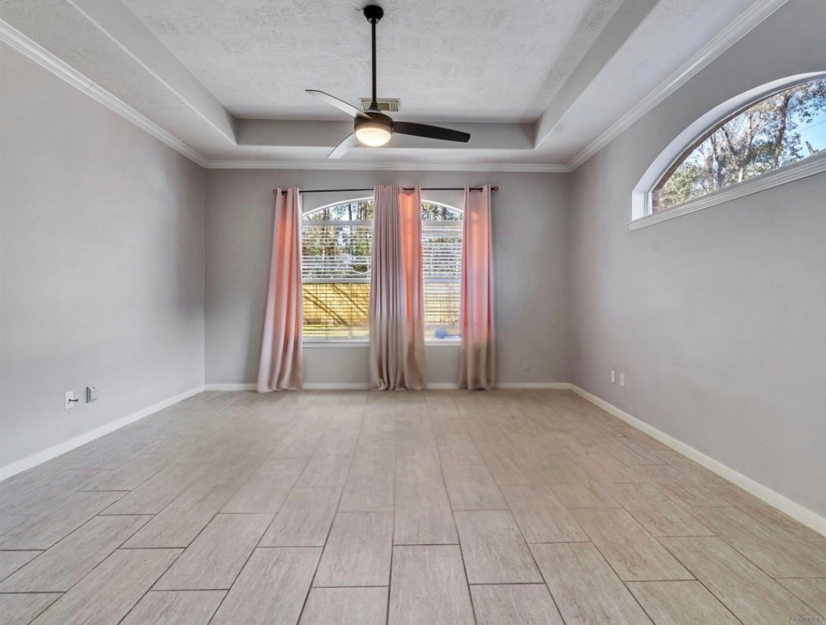 2615 Fern Lacy Drive Spring, TX 77388 - Photo 18 of 33 The primary suite is large and has crown molding, a custom window that helps provide plenty of natural light