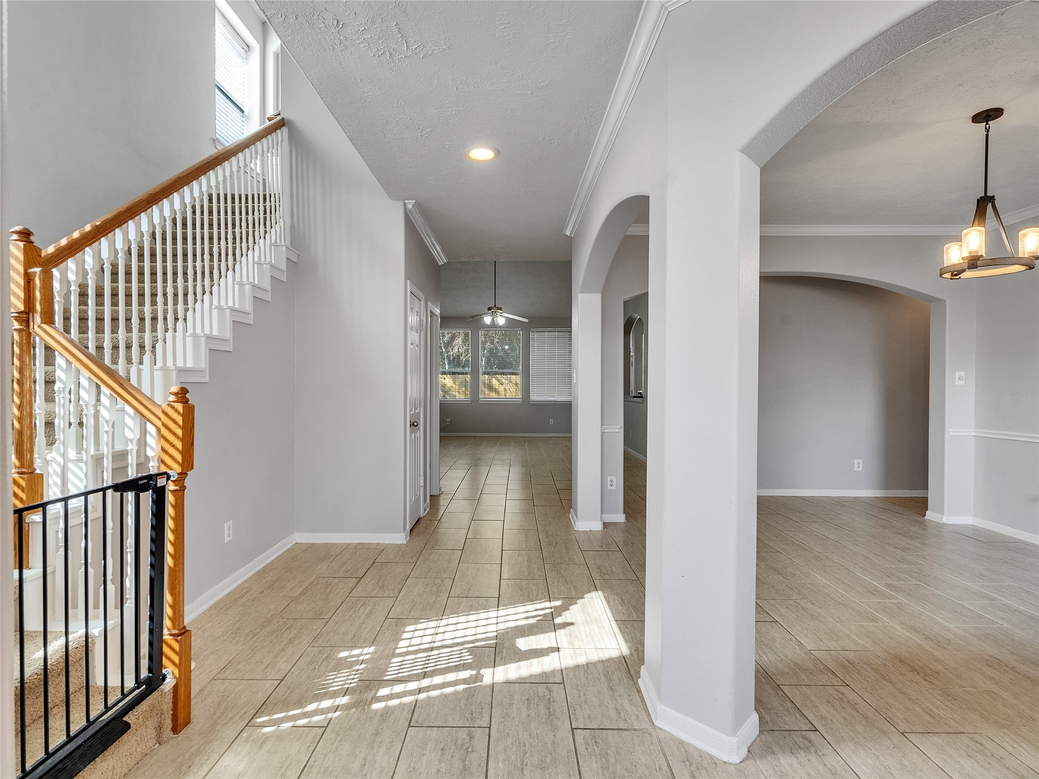 2615 Fern Lacy Drive Spring, TX 77388 - Photo 4 of 33 The entryway features the dining area to the right, stairs to the remaining bedrooms to the left and grand open concept living room and kitchen to the back end