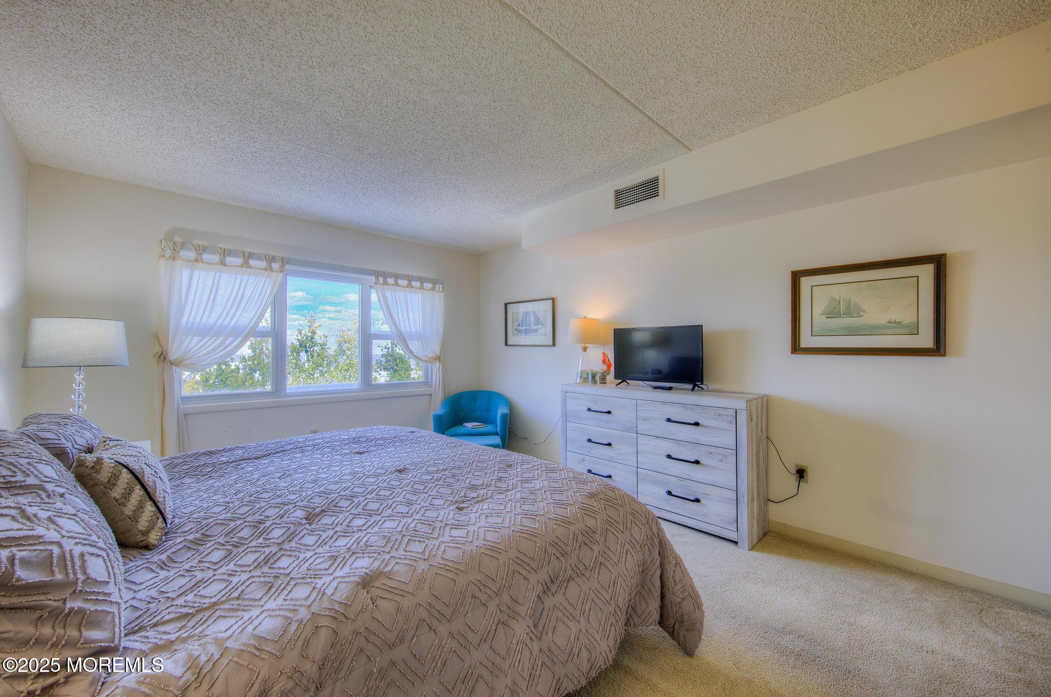 32 Center Avenue, Unit 17 Atlantic Highlands, NJ 07716 - Photo 13 of 27 a bedroom with a large bed and a window
