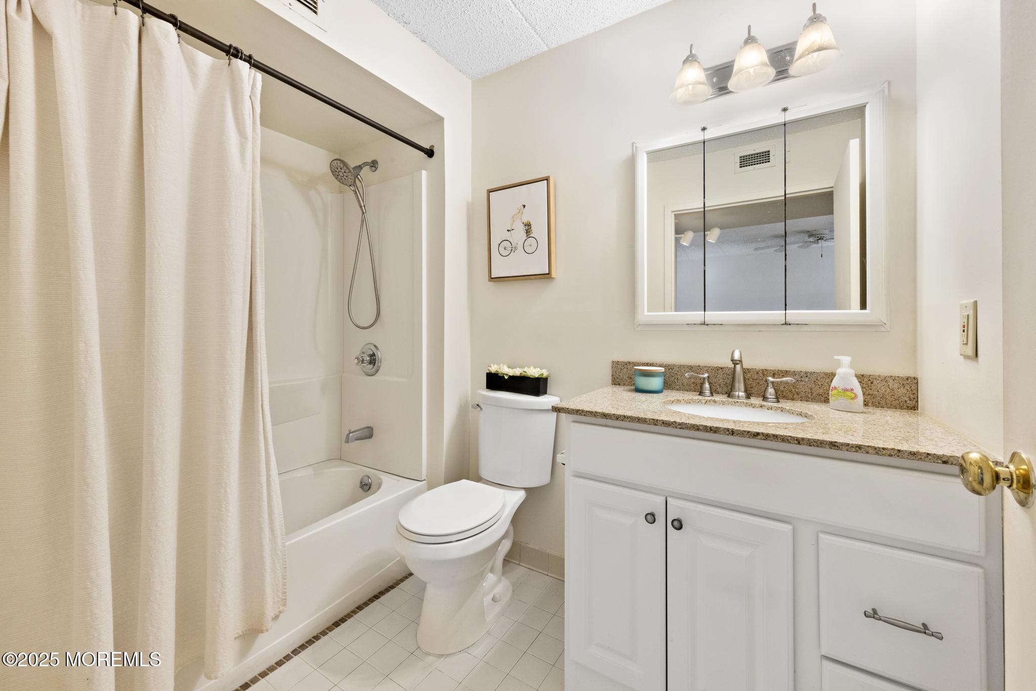 32 Center Avenue, Unit 17 Atlantic Highlands, NJ 07716 - Photo 17 of 27 a bathroom with a sink a toilet and shower