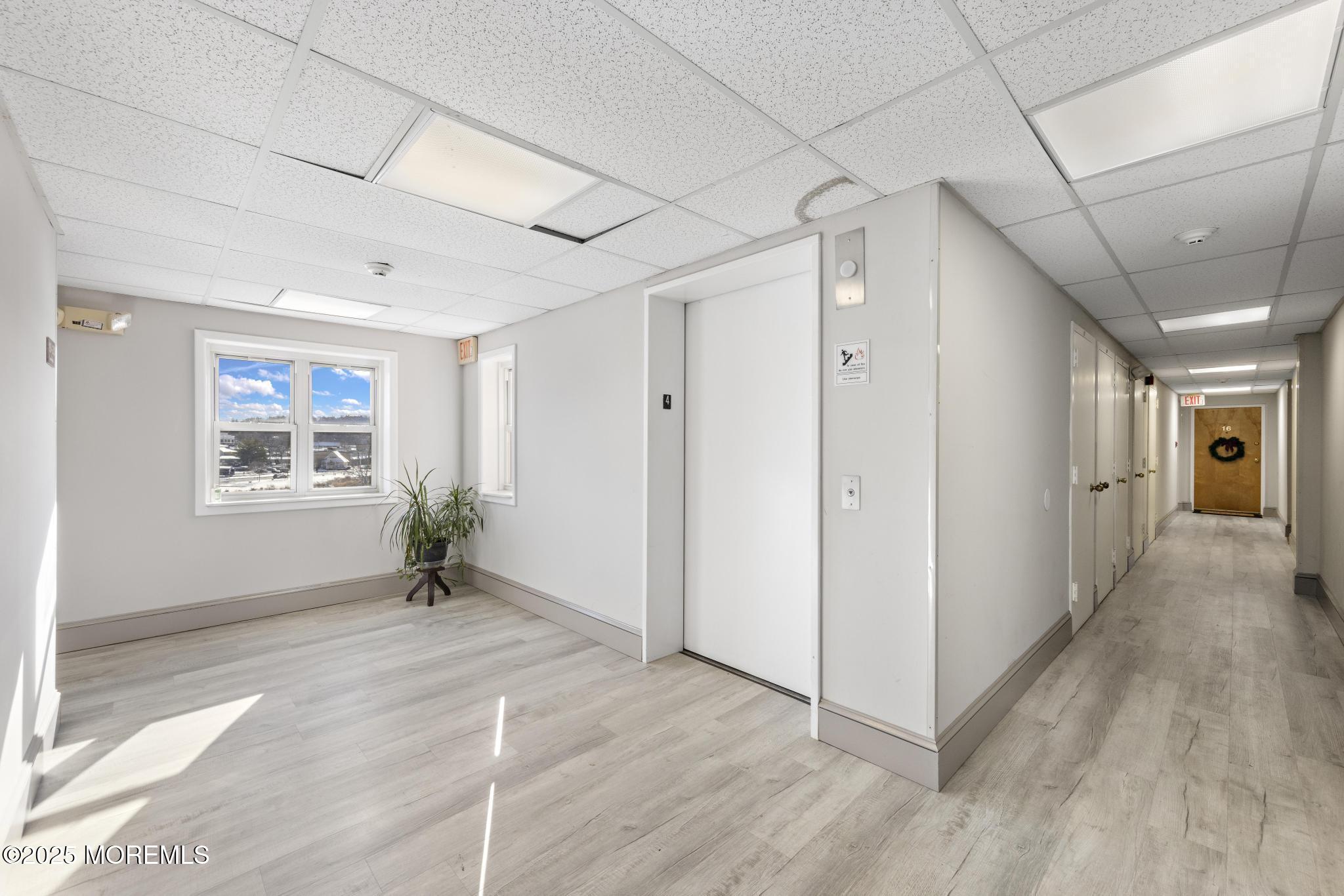 32 Center Avenue, Unit 17 Atlantic Highlands, NJ 07716 - Photo 20 of 27 a view of entryway with window and wooden floor