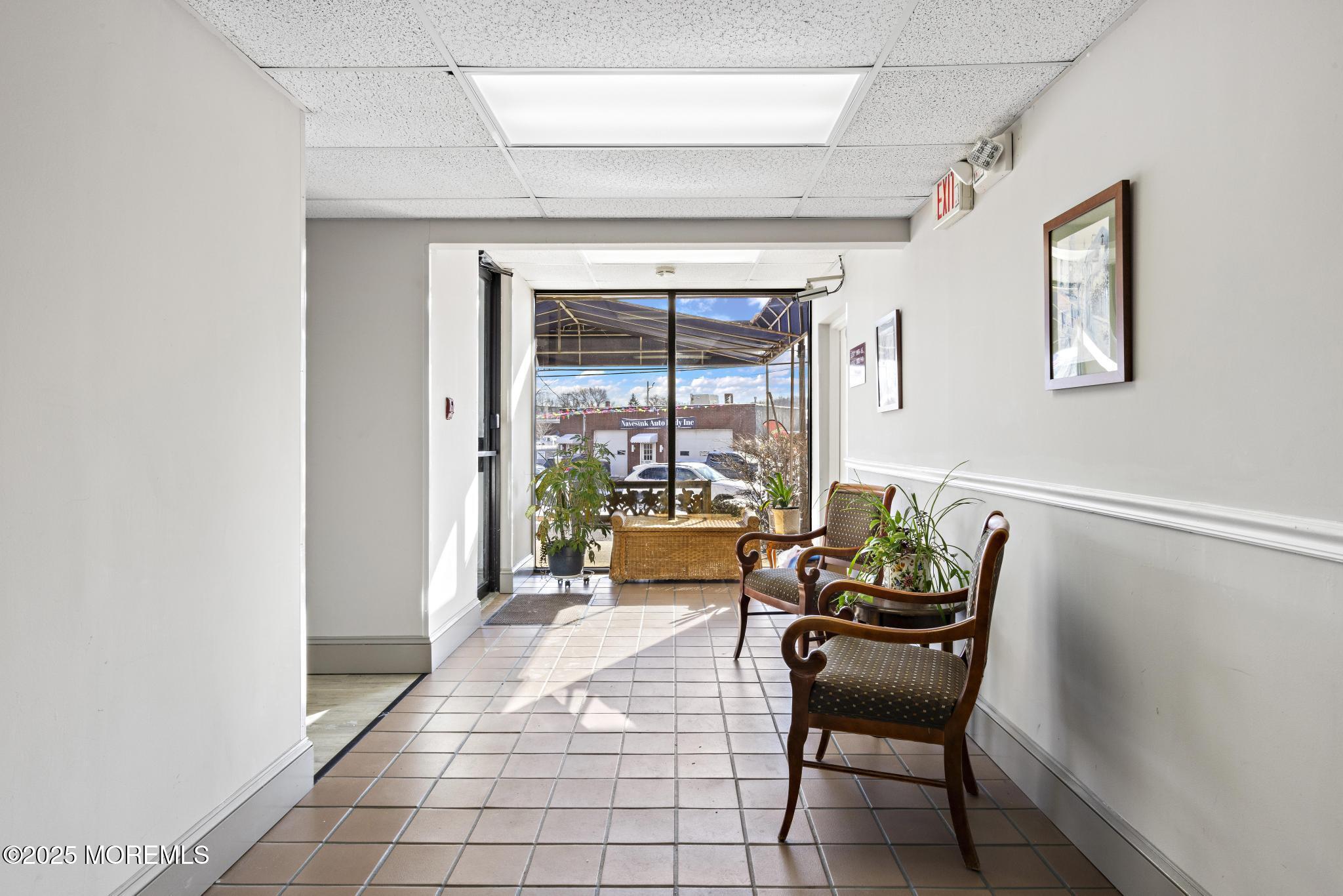 32 Center Avenue, Unit 17 Atlantic Highlands, NJ 07716 - Photo 21 of 27 a living room with furniture and a window
