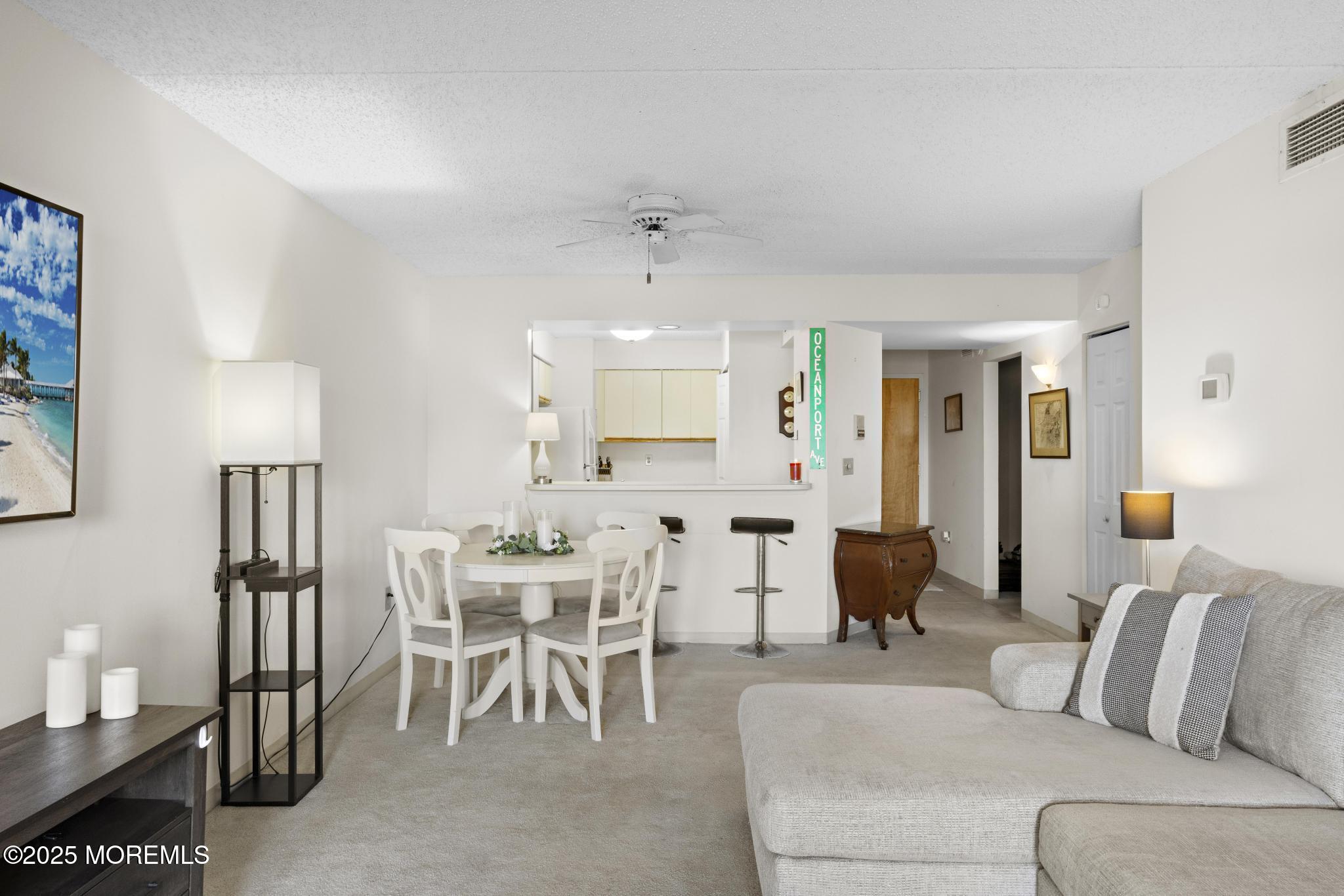 32 Center Avenue, Unit 17 Atlantic Highlands, NJ 07716 - Photo 6 of 27 a living room with furniture and a lamp
