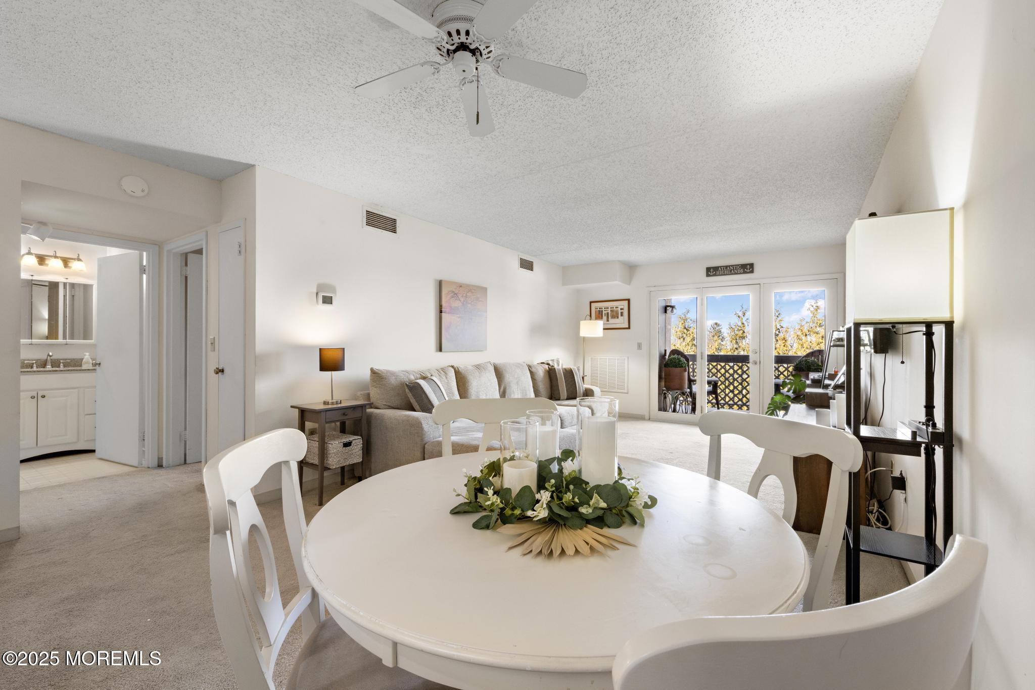 32 Center Avenue, Unit 17 Atlantic Highlands, NJ 07716 - Photo 8 of 27 a living room with furniture and a refrigerator