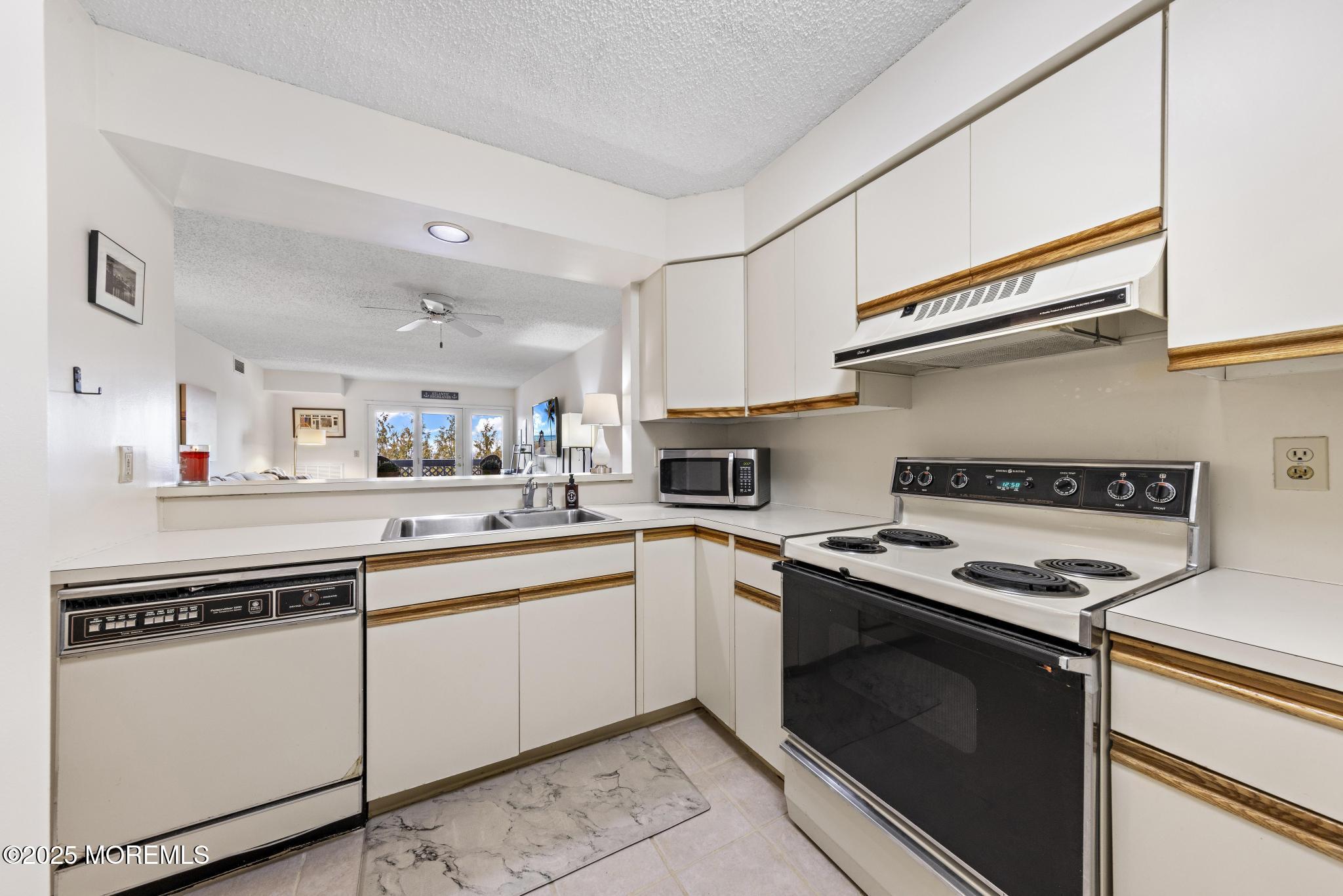 32 Center Avenue, Unit 17 Atlantic Highlands, NJ 07716 - Photo 10 of 27 a kitchen with cabinets appliances and a sink