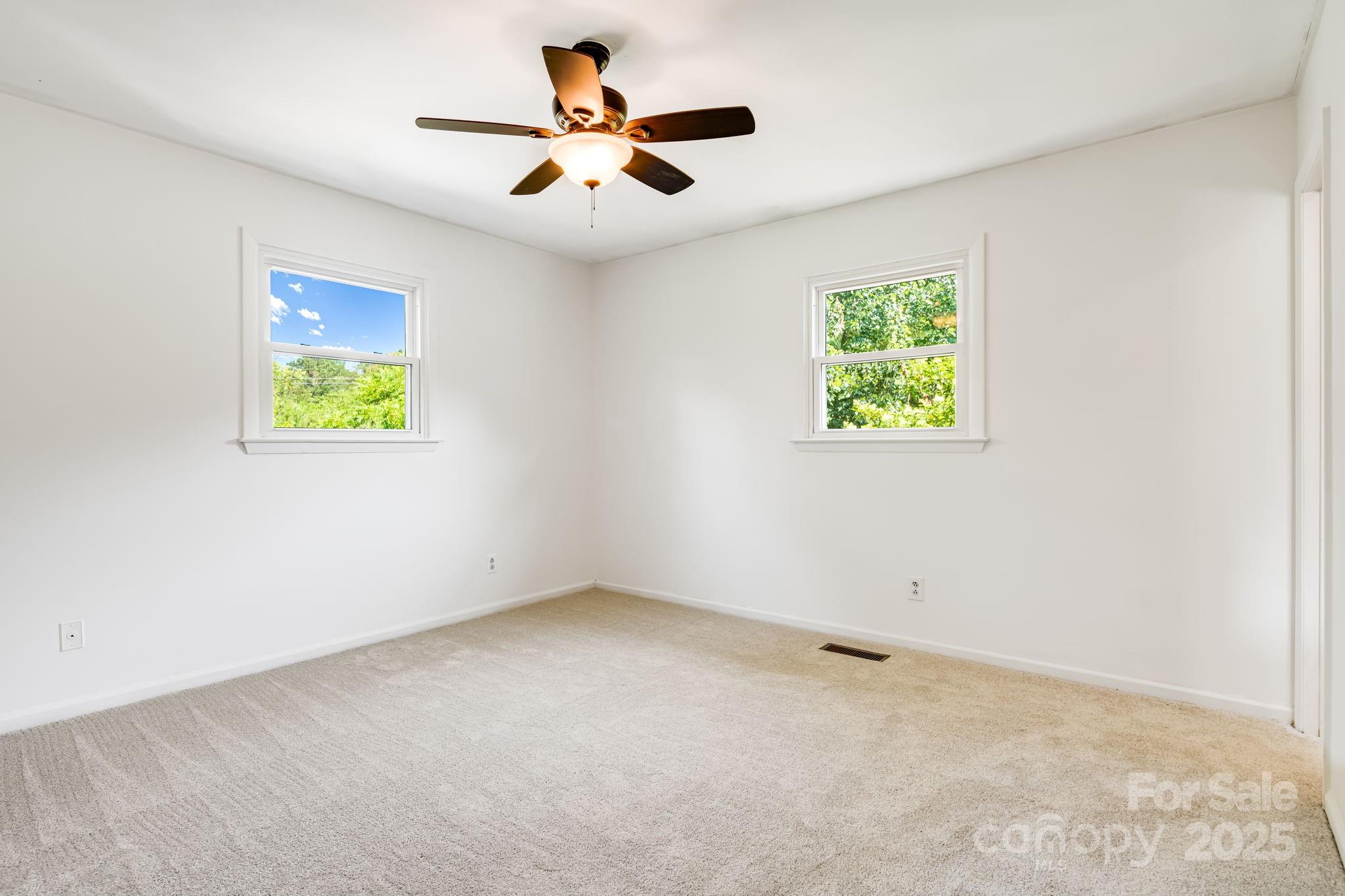 1360 Jupiter Road Weaverville, NC 28787 - Photo 11 of 39 an empty room with windows and fan