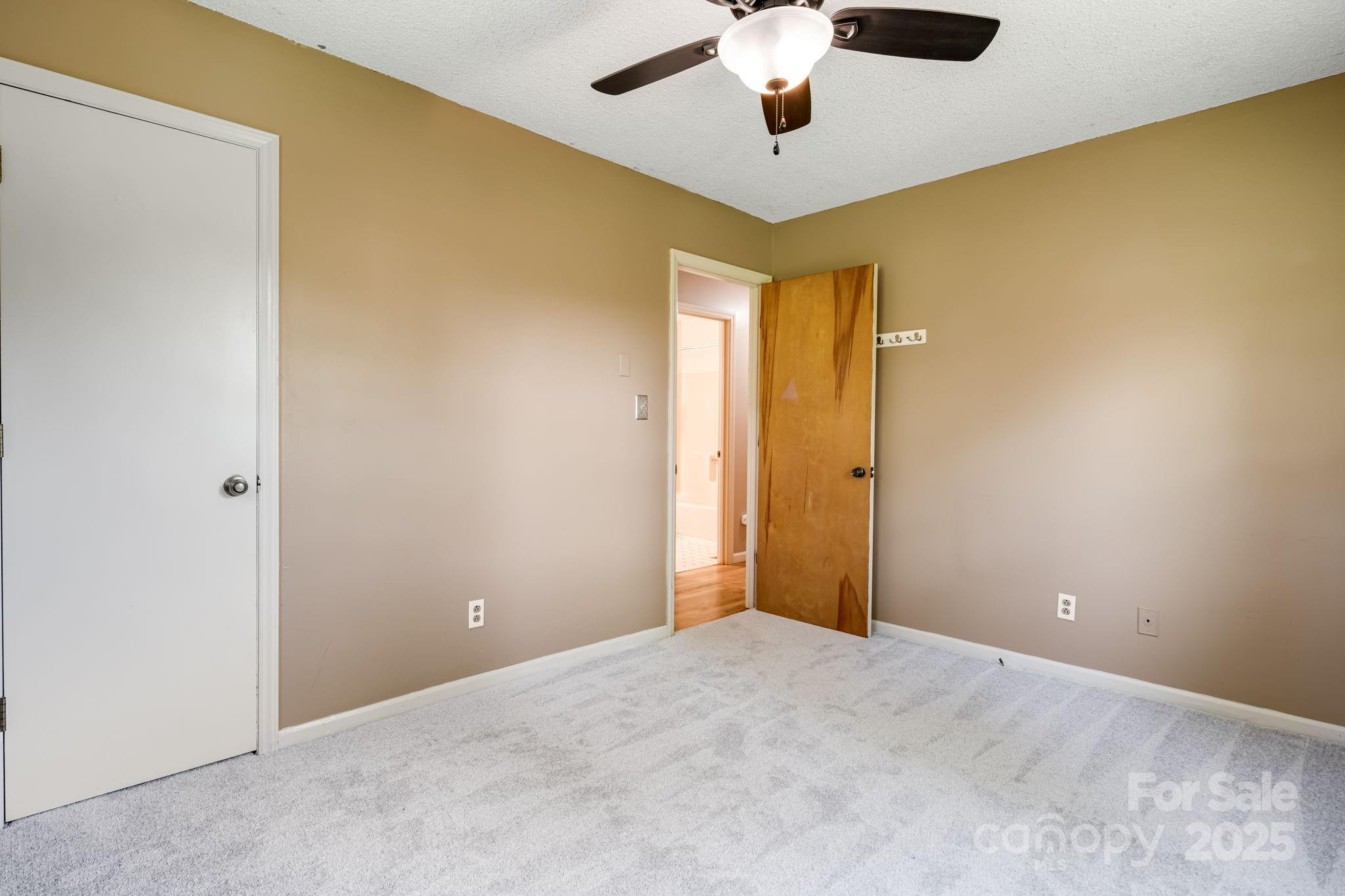 1360 Jupiter Road Weaverville, NC 28787 - Photo 14 of 39 an empty room with a ceiling fan and a fan