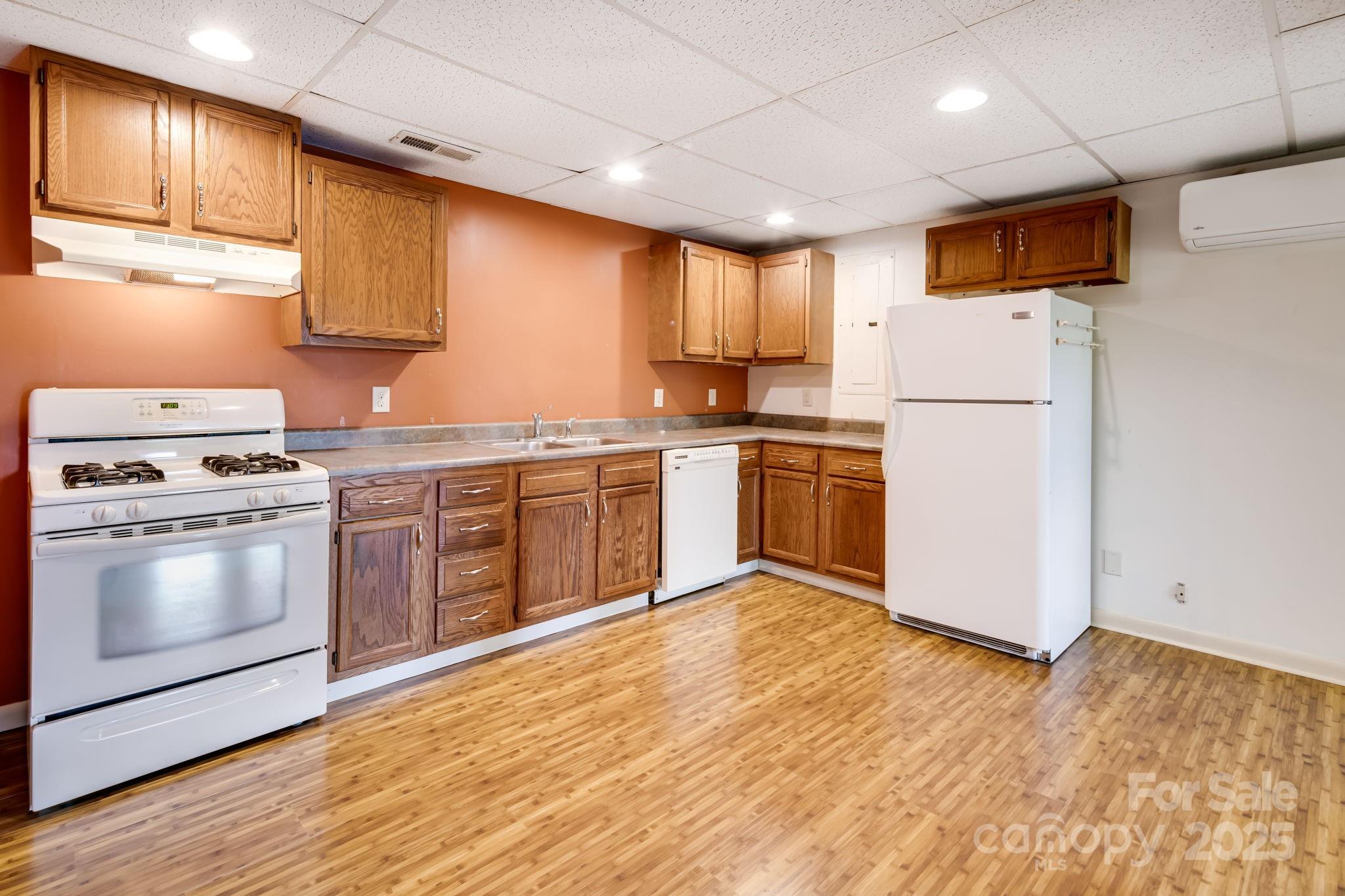 1360 Jupiter Road Weaverville, NC 28787 - Photo 19 of 39 a kitchen with stainless steel appliances granite countertop a stove a refrigerator and a microwave