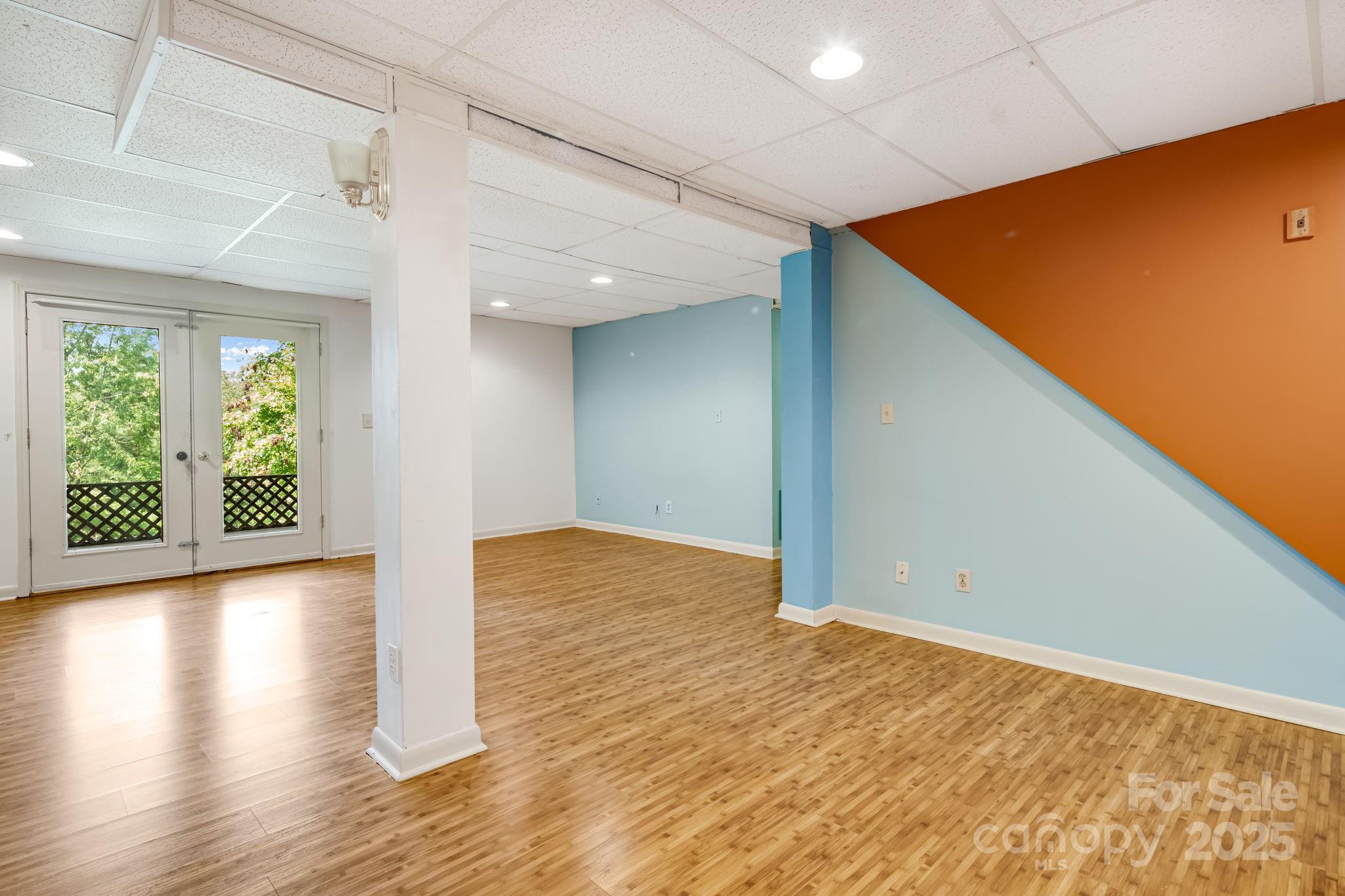1360 Jupiter Road Weaverville, NC 28787 - Photo 21 of 39 a view of empty room with wooden floor and fan