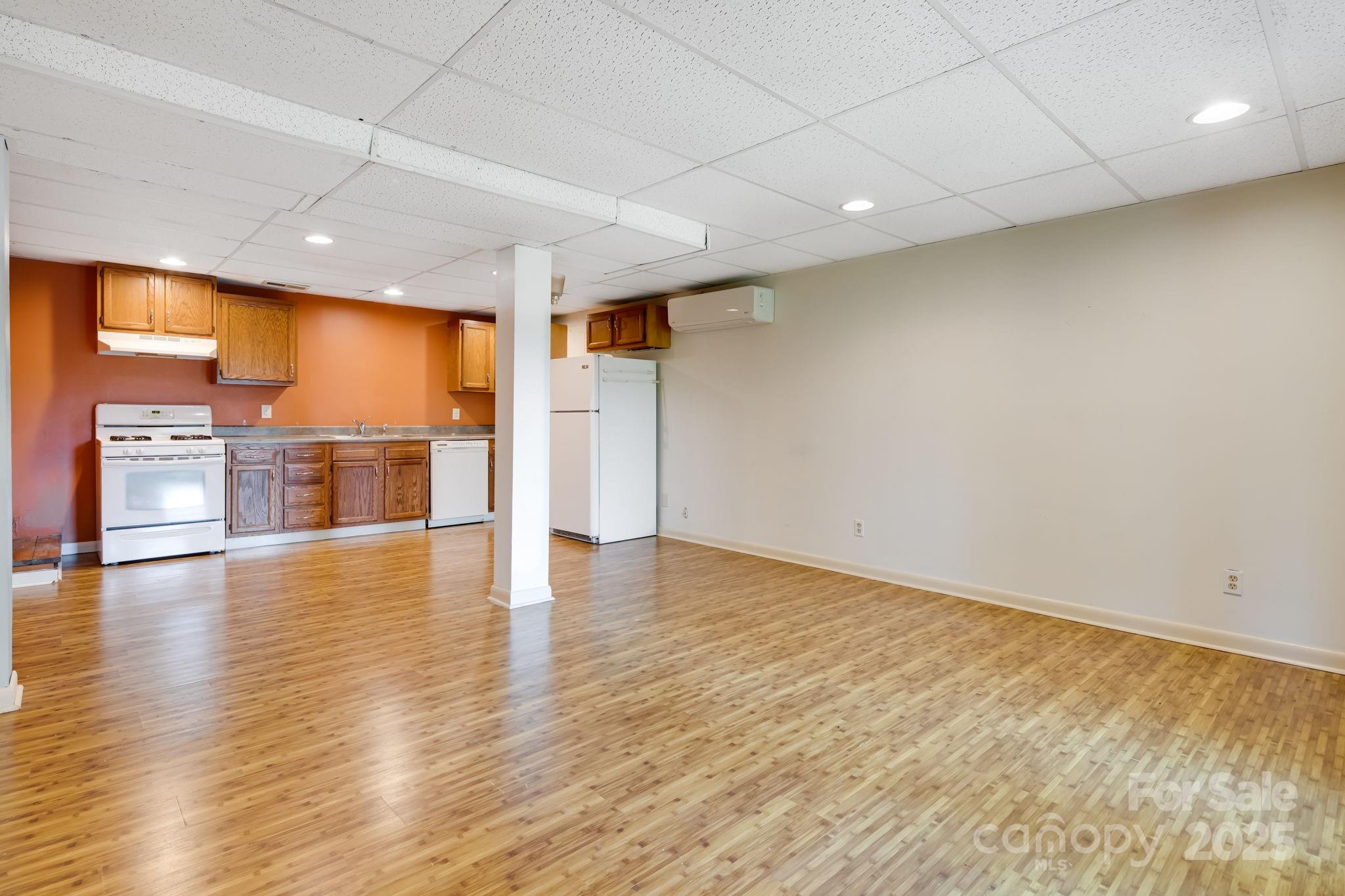 1360 Jupiter Road Weaverville, NC 28787 - Photo 22 of 39 an empty room with wooden floor and windows