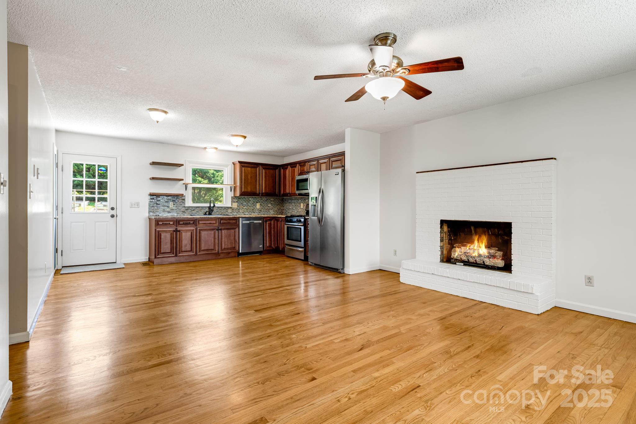 1360 Jupiter Road Weaverville, NC 28787 - Photo 6 of 39 a view of an empty room with a kitchen and a window
