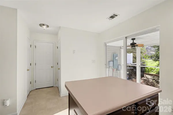 a view of a kitchen with a stove wooden cabinets and a refrigerator