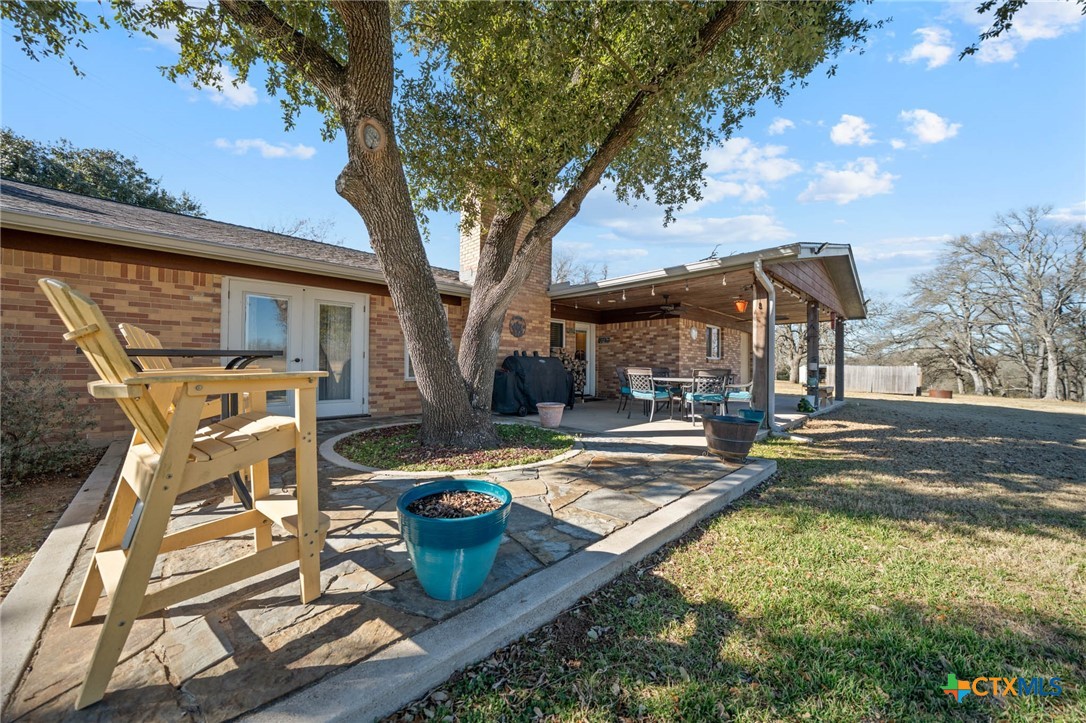 2443 Highway 36 Cameron, TX 76520 - Photo 24 of 34 a view of a patio with couches table and chairs with wooden fence and floor