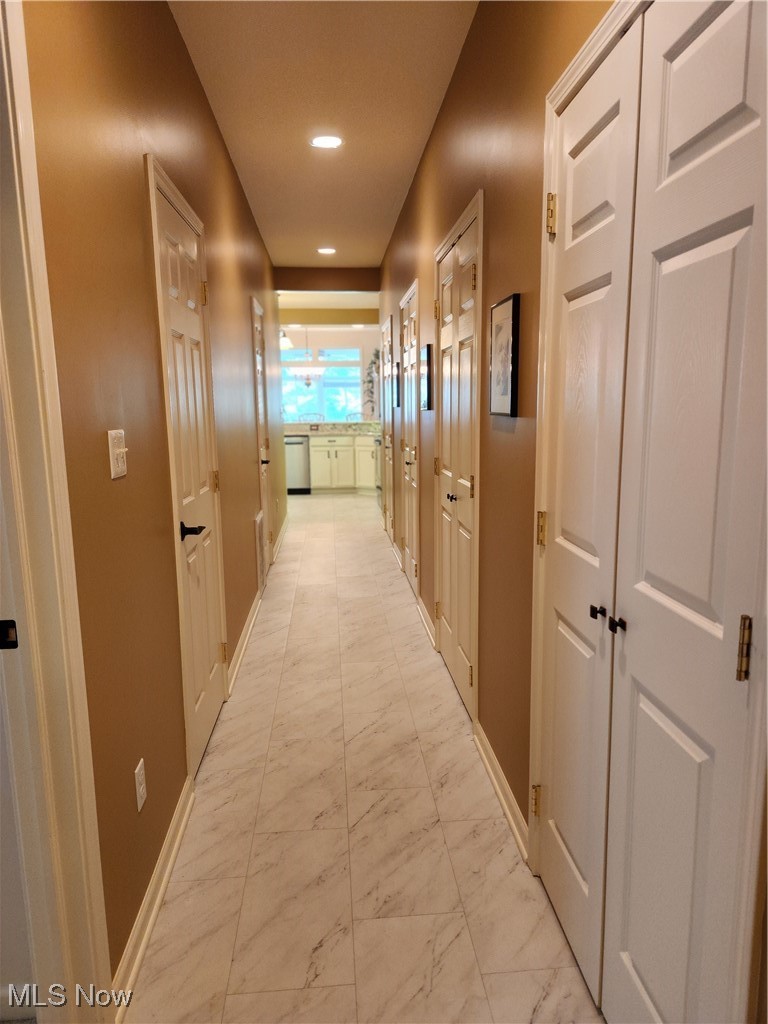 5645 Clingan Road, Unit 18A Struthers, OH 44471 - Photo 15 of 38 Hall with light marble finish floors, recessed lighting, lighted pantry & lighted closets for storage.