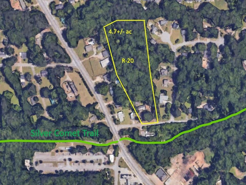 front view of a house with a yard and potted plants